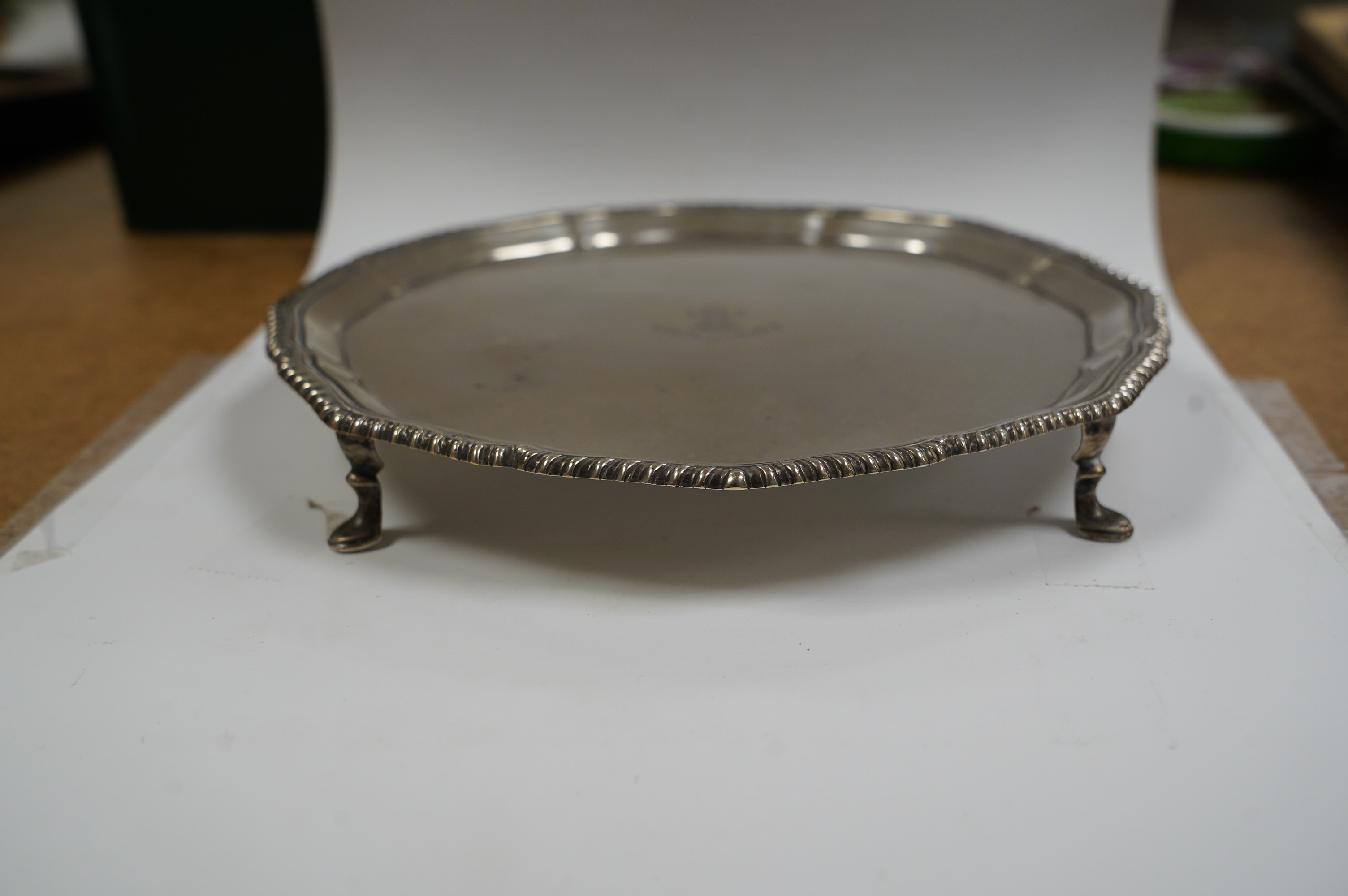 A George V silver shaped circular waiter, with engraved signatures, by Theodore Rossi, London, 1913, on four hoof feet, 203cm, 13.6oz. Condition - fair